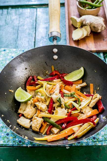 Chicken with ginger and vegetables in a wok — Stock Photo
