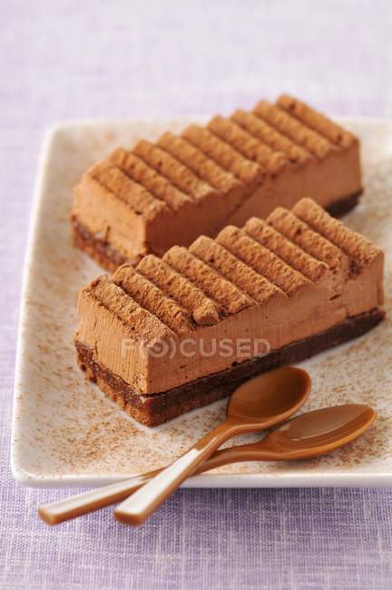 Closeup view of two chocolate Fondants with spoons on plate — Stock Photo