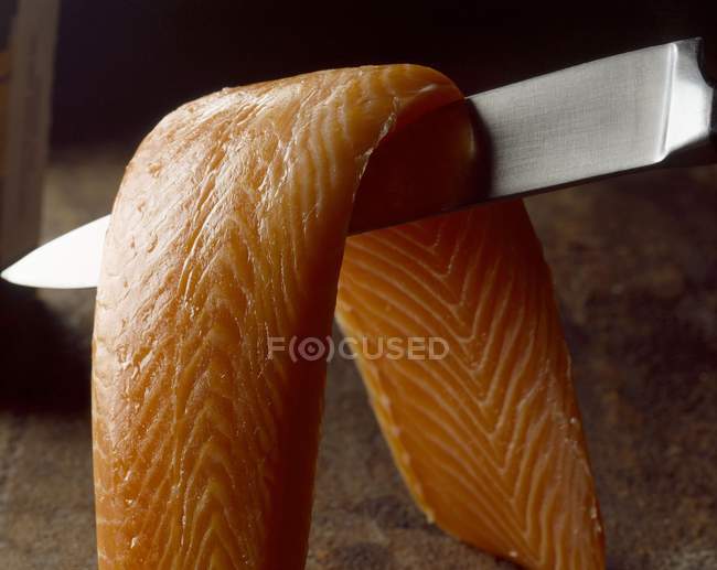 Salmon fillet on knife — Stock Photo