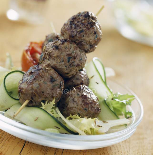 Cumin kebabs on white plate — Stock Photo