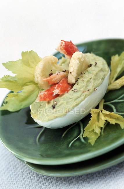 Egg with avocado cream and shrimps — Stock Photo