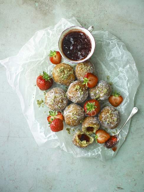 Strawberry doughnuts on baking paper — Stock Photo
