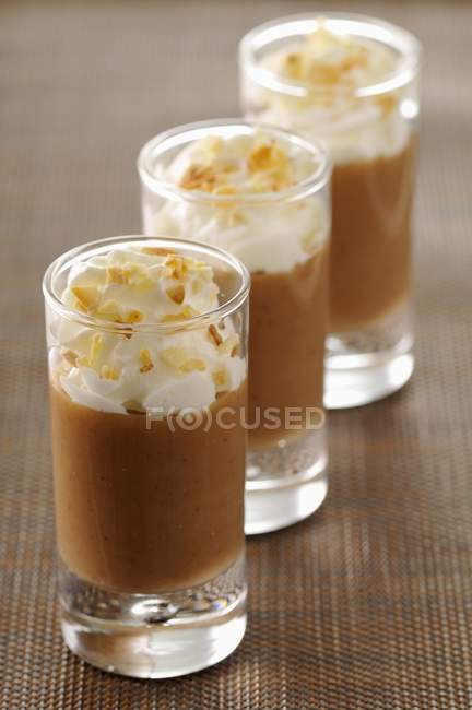 Closeup view of chestnut cream with whipped cream in three glasses — Stock Photo
