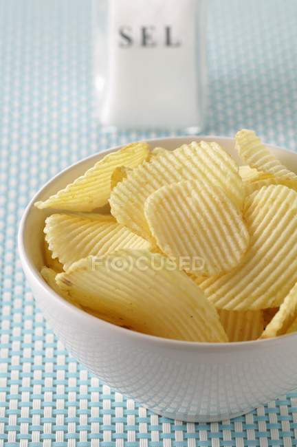Potato crisps in white bowl — Stock Photo