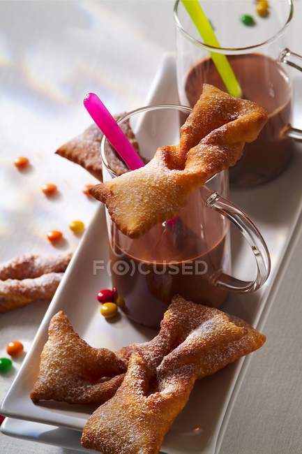 Closeup view of orange flower fritters with hot chocolate — Stock Photo