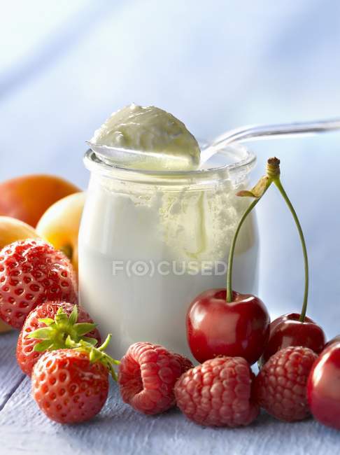 Open yogurt in a glass pot — Stock Photo