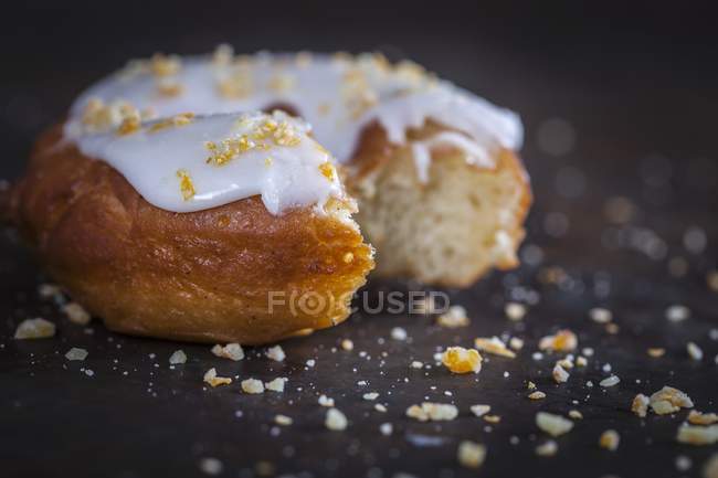 Closeup view of donut with lemon glaze and candied orange — Stock Photo