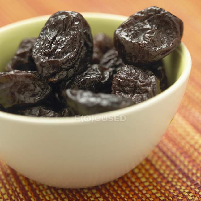 Closeup view of prunes in white bowl — Stock Photo