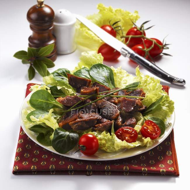 Salad with gizzards on plate — Stock Photo