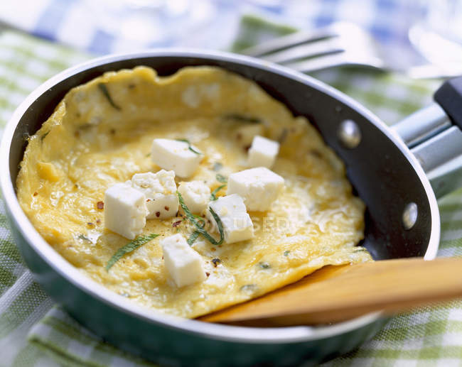 Omelette with feta in pan — Stock Photo