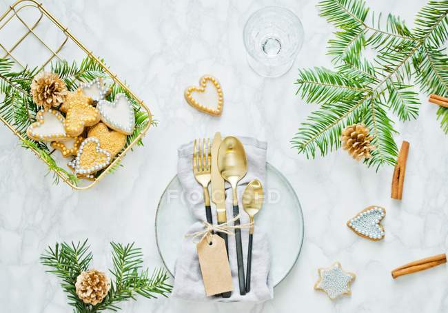 Top view of Christmas table setting with cookies, fir branches and cinnamon sticks — Stock Photo