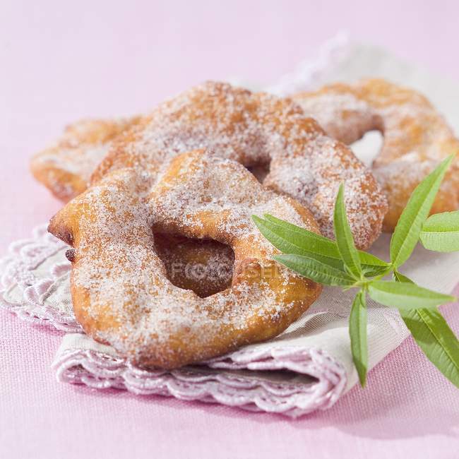 Closeup view of Bugnes arlesiennes in sugar icing on cloth — Stock Photo