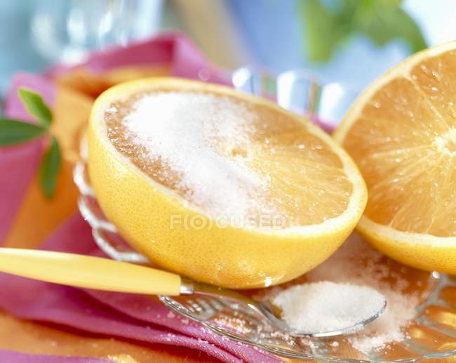 Fresh halved grapefruit with sugar — Stock Photo