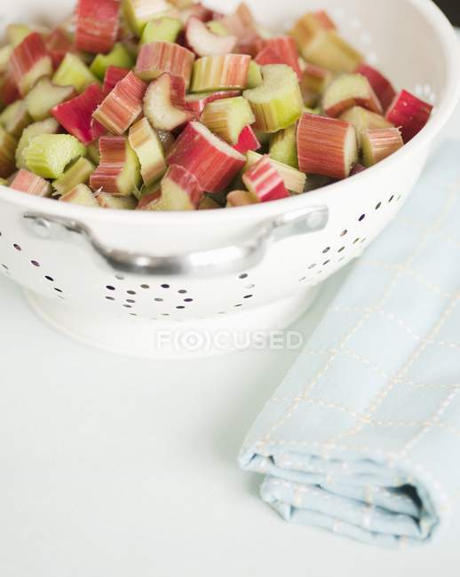 Chopped rhubarb in colander — Stock Photo