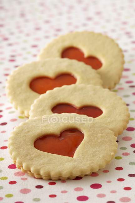 Jam cookies on colorful tablecloth — Stock Photo