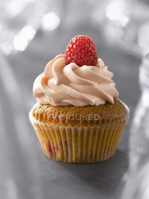 Cupcake de frambuesa con bayas en la parte superior - foto de stock