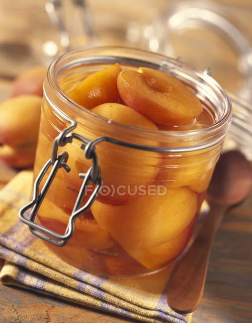 Jar of apricots in syrup — Stock Photo