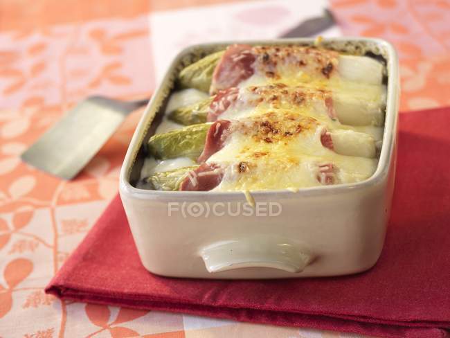 Chicory with ham and cheese — Stock Photo