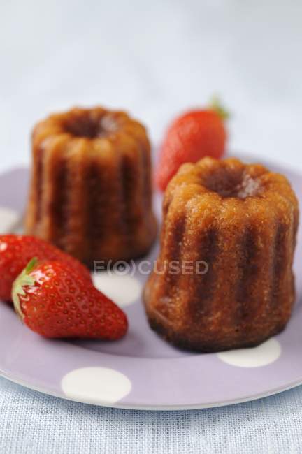 Closeup view of Cannels puddings and strawberries — Stock Photo