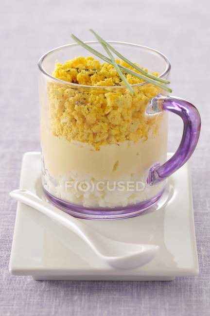 Egg mimosa Verrine in cup over plate with spoon — Stock Photo