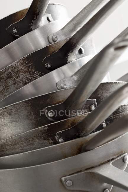 Closeup view of stacked metal saucepans — Stock Photo