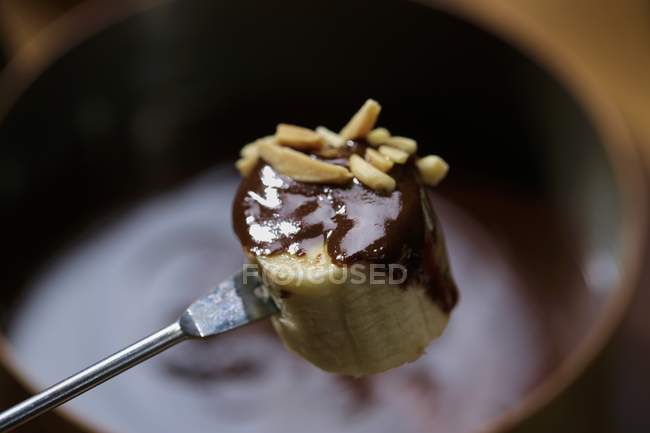 Chocolate fondue with banana — Stock Photo