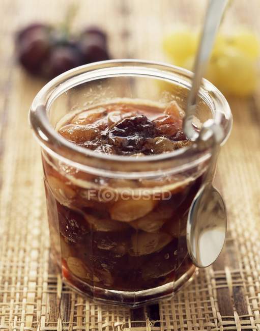 Grape jam in glass with spoon — Stock Photo