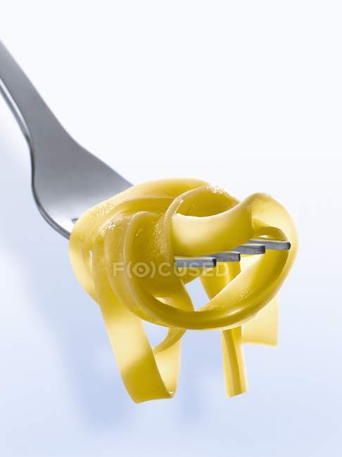 Fresh cooked tagliatelle pasta on fork — Stock Photo