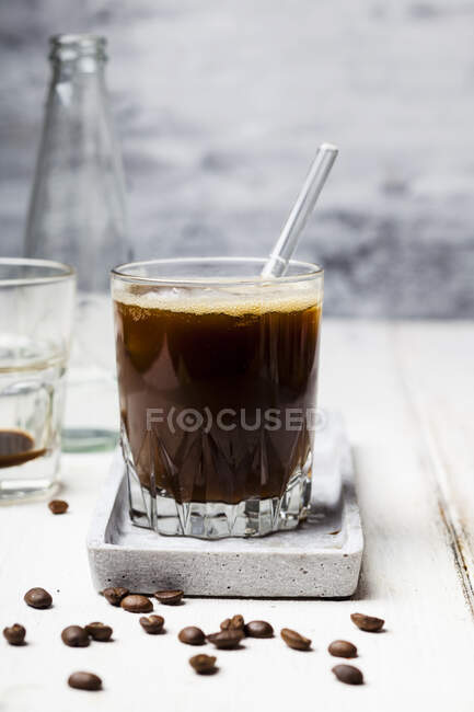 Espresso with sparkling water and ice cubes — Stock Photo