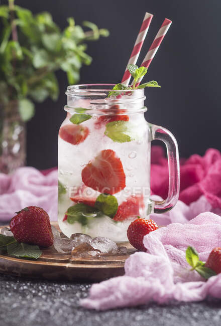 Cóctel de verano Mojito con fresas, menta y hielo - foto de stock