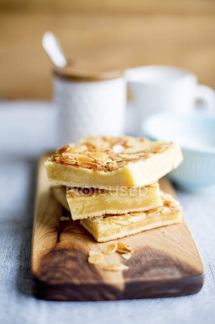 Stack of butter cake slices with flaked almonds — Stock Photo