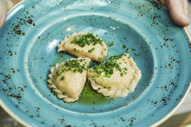 Austrian ravioli filled with quark and potatoes with chives on plate — Stock Photo