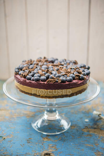 Blueberry cake on glass stand — Stock Photo