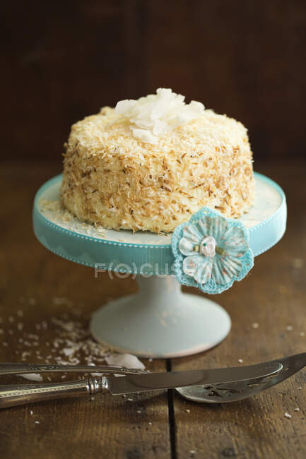 Coconut Cake on blue stand — Stock Photo