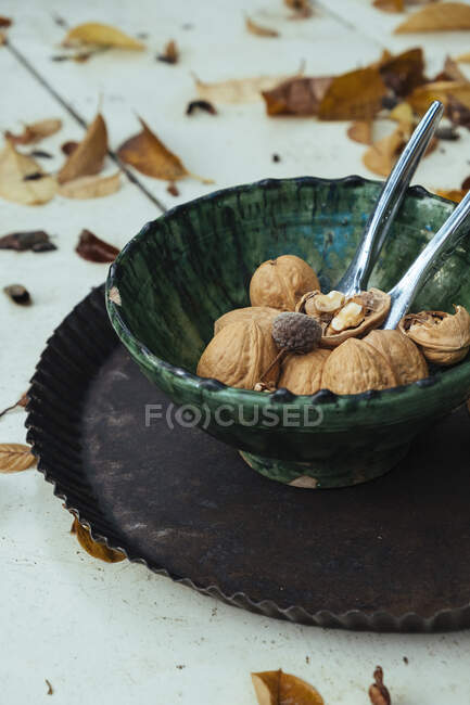Walnuts with autumn leaves — Stock Photo