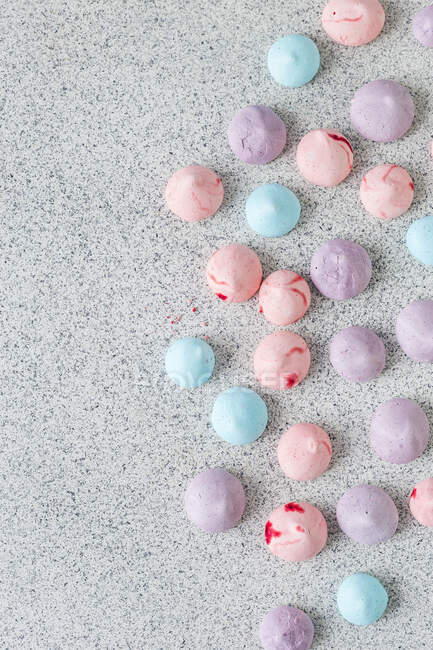 Colorful meringues on stone kitchen counter — Stock Photo
