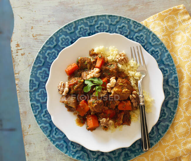 Lamb tagine with carrots, walnuts and couscous — Stock Photo