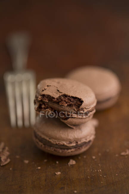 Close up shot of Chocolate macarons with fork on background — Stock Photo