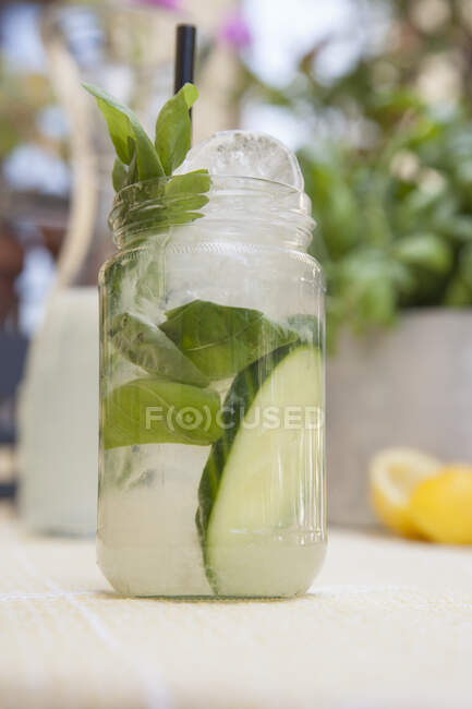 Lemonade with cucumber and basil in glass mug — Stock Photo