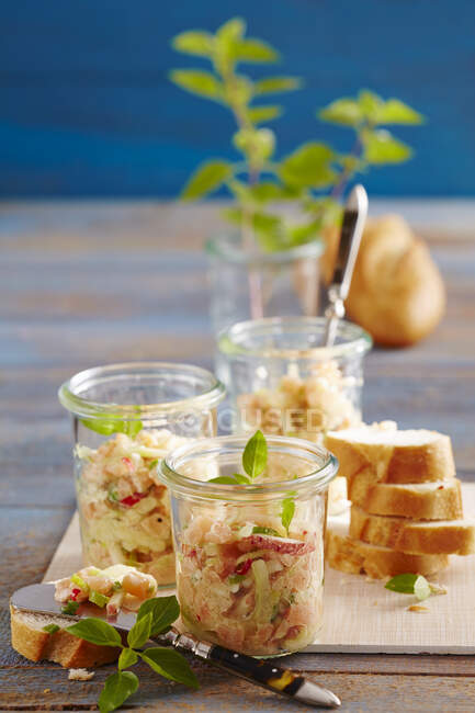 Oriental salmon tartare in jars with baguette — Stock Photo