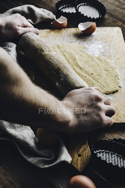 Rolling the dough on mini tarts — Stock Photo