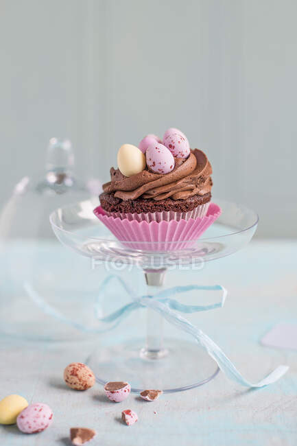 Easter chocolate cupcake on a glass stand — Stock Photo