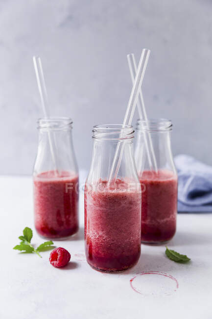 Bottles of raspberry smoothies — Stock Photo