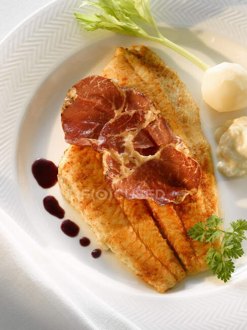 Plaice with prosciutto and truffle jus — Stock Photo