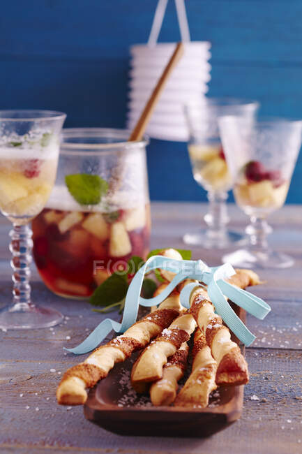 Pineapple and raspberries punch with spicy yeast dough and puff pasty Parmesan sticks — Stock Photo