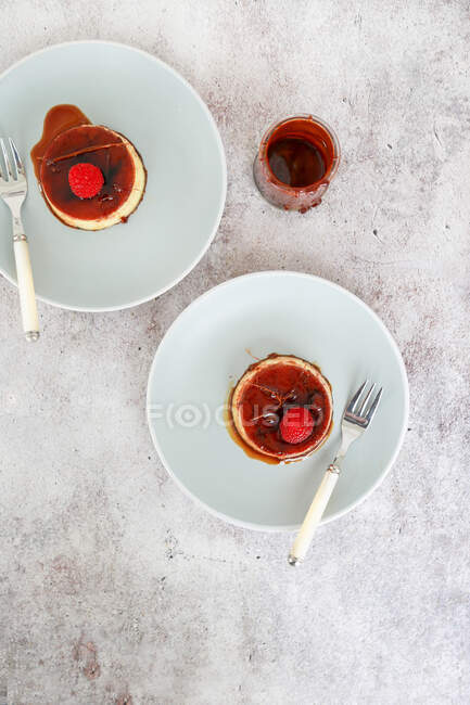 Creme caramel with raspberry — Stock Photo