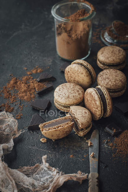 Chocolate macaroons with cocoa powder in glass — Stock Photo