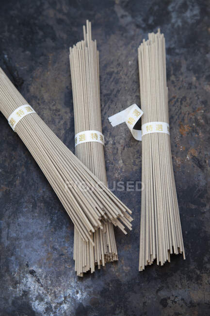 Three bundles of soba noodles made from buckwheat — Stock Photo