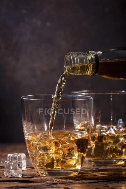 Whiskey with ice in glasses — Stock Photo