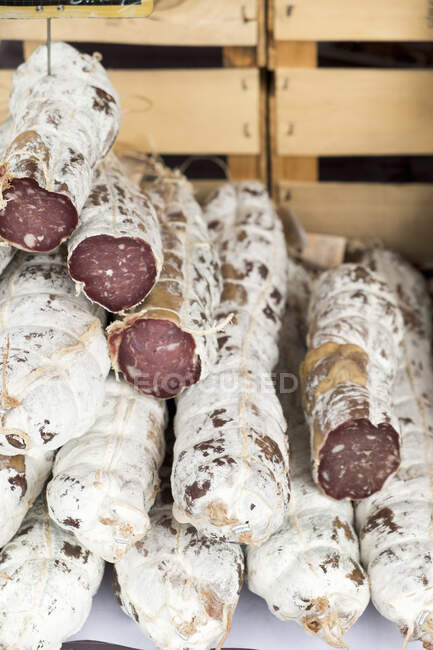 French sausage in a wooden box — Stock Photo